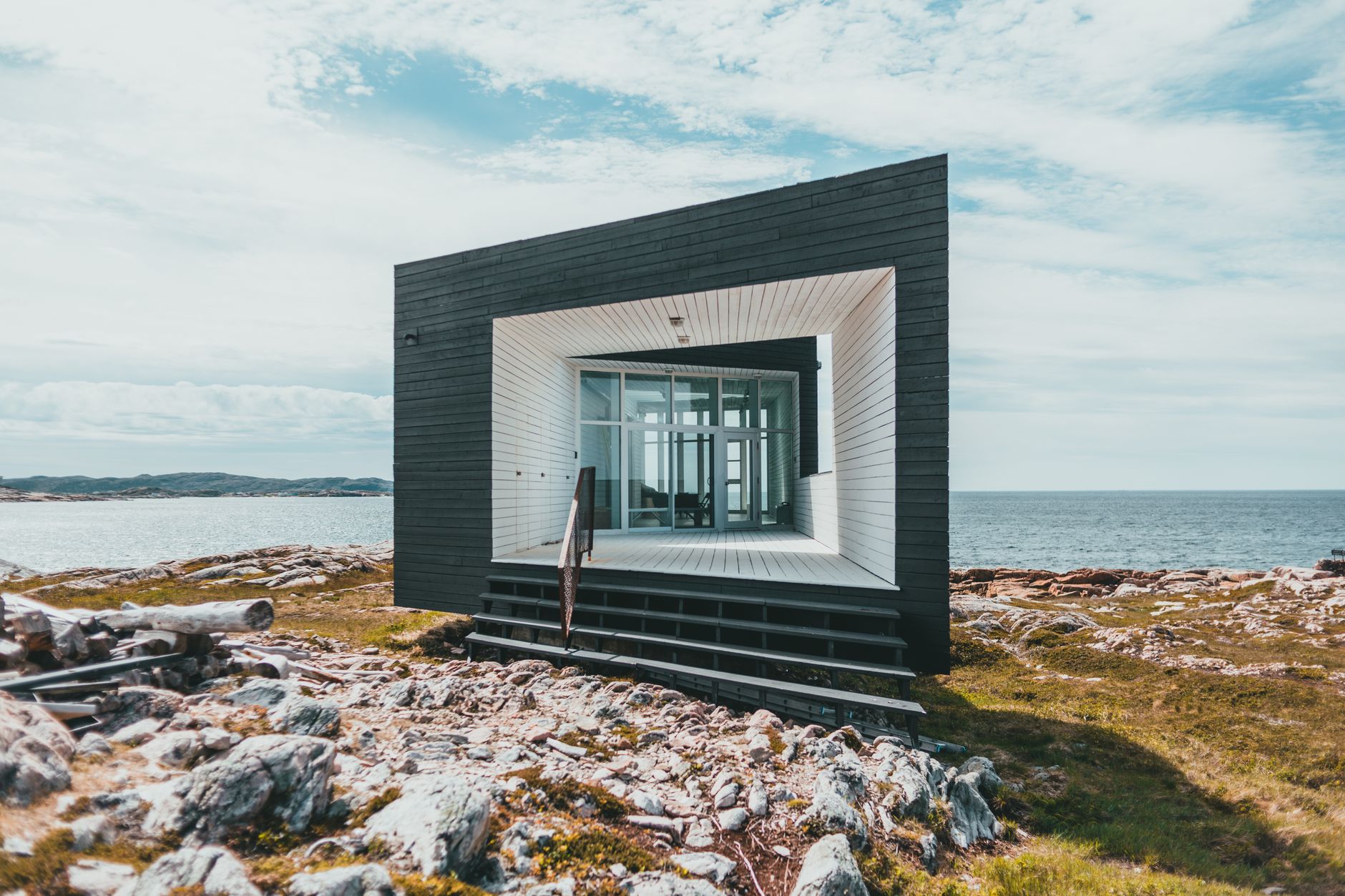 Minimalist Nordic timber cabin overlooking misty water