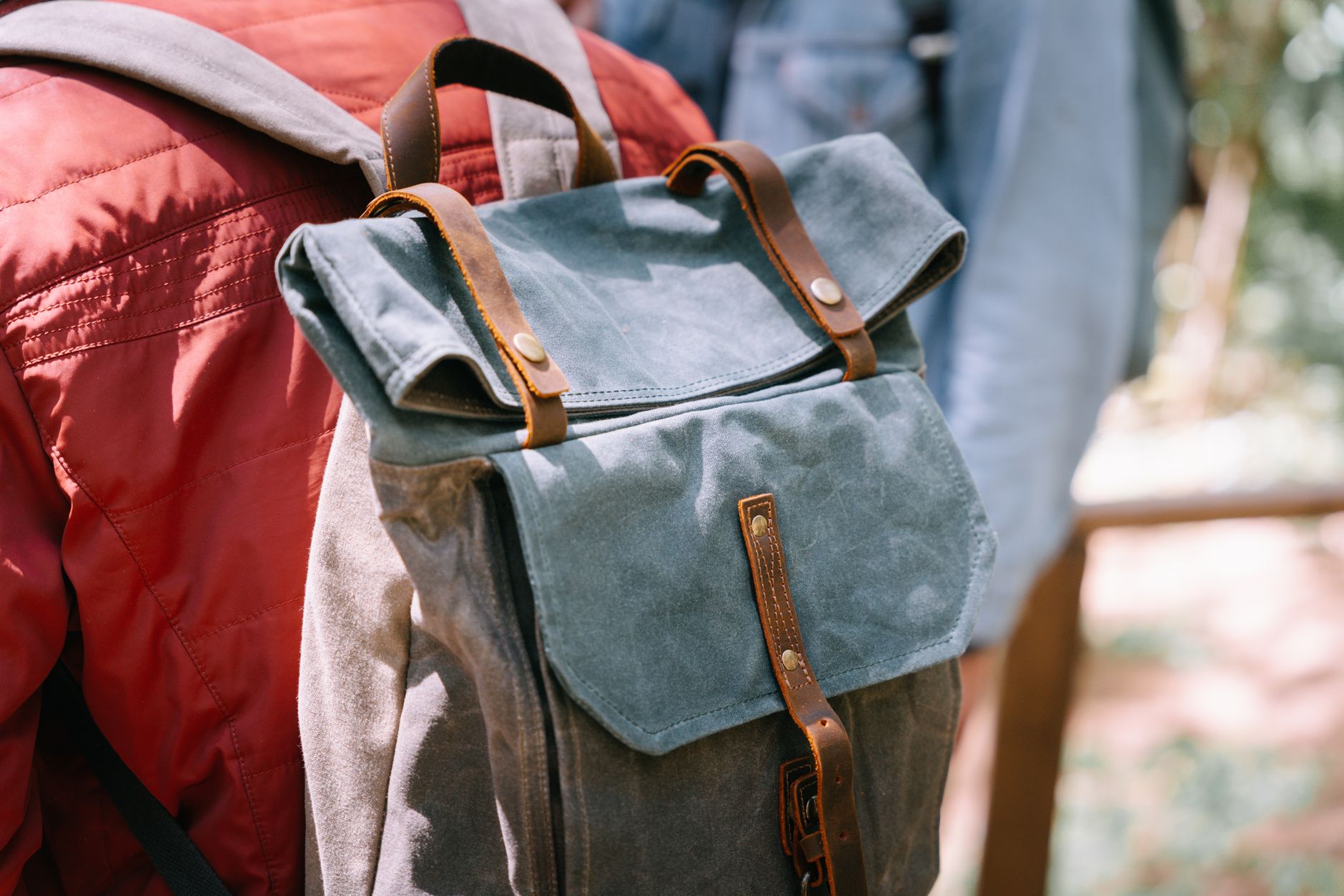 Traveler with leather backpack gazing at desert canyon